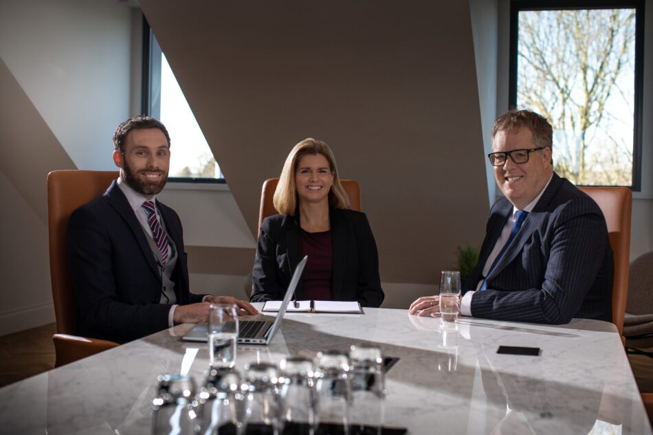 Three employers seated around a conference table