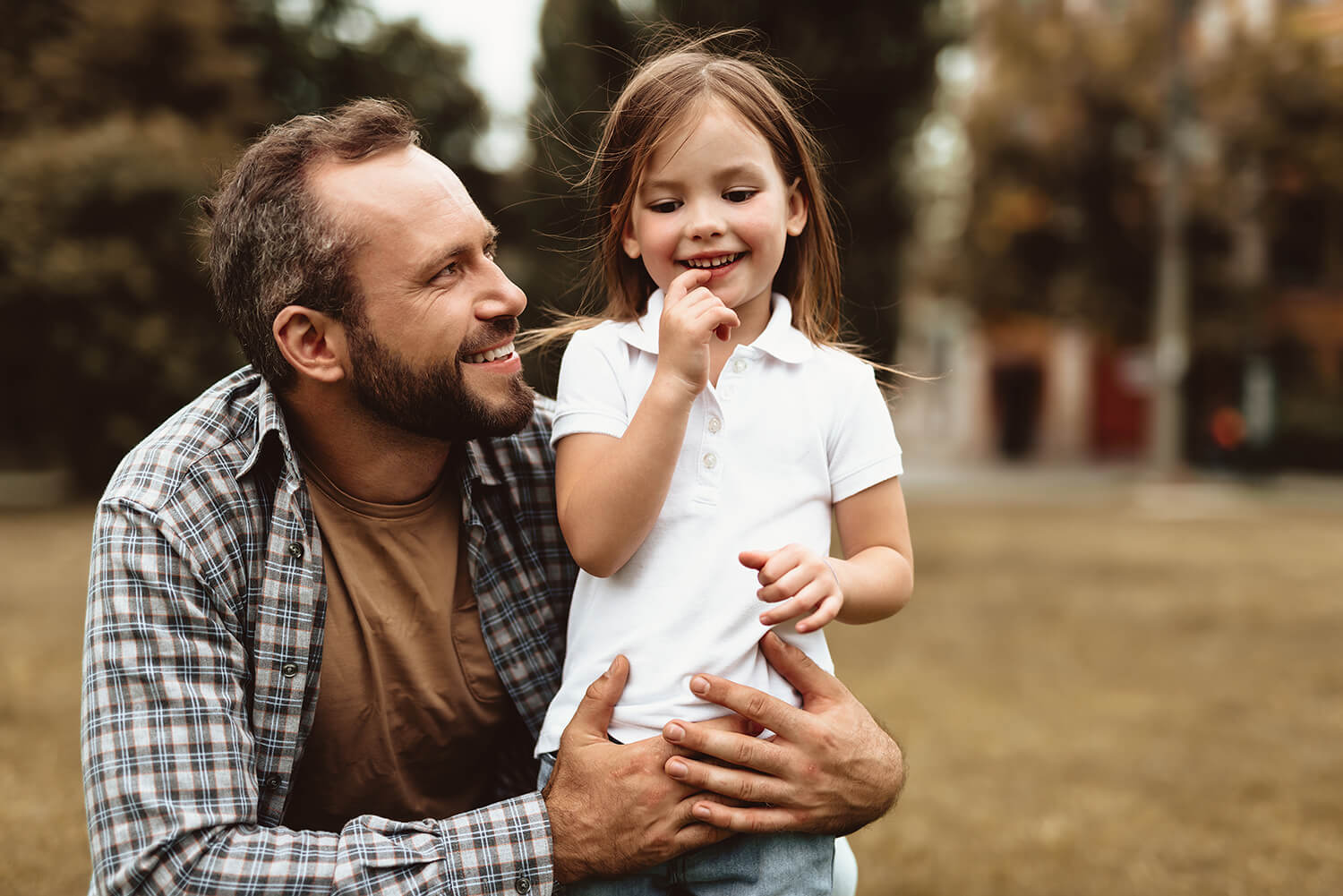 Smiling father and daughter spending time together in Alderley Edge, representing positive co-parenting.