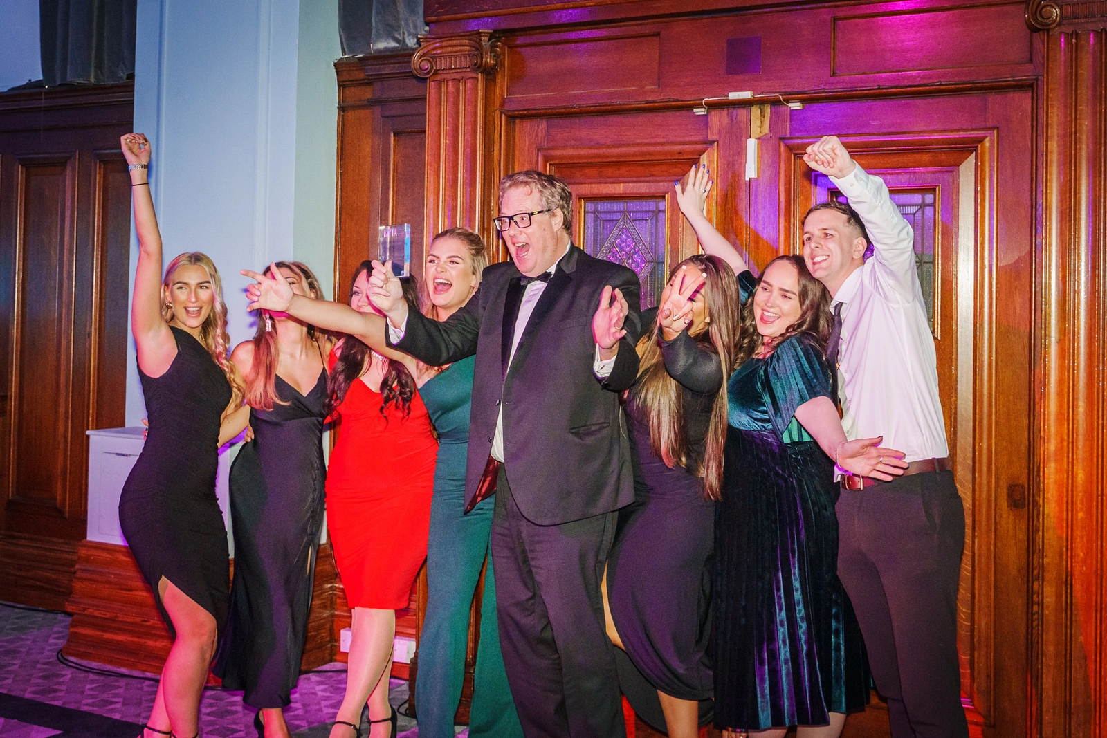 McAlister Family Law team celebrating together at an award ceremony with a sense of achievement and unity.